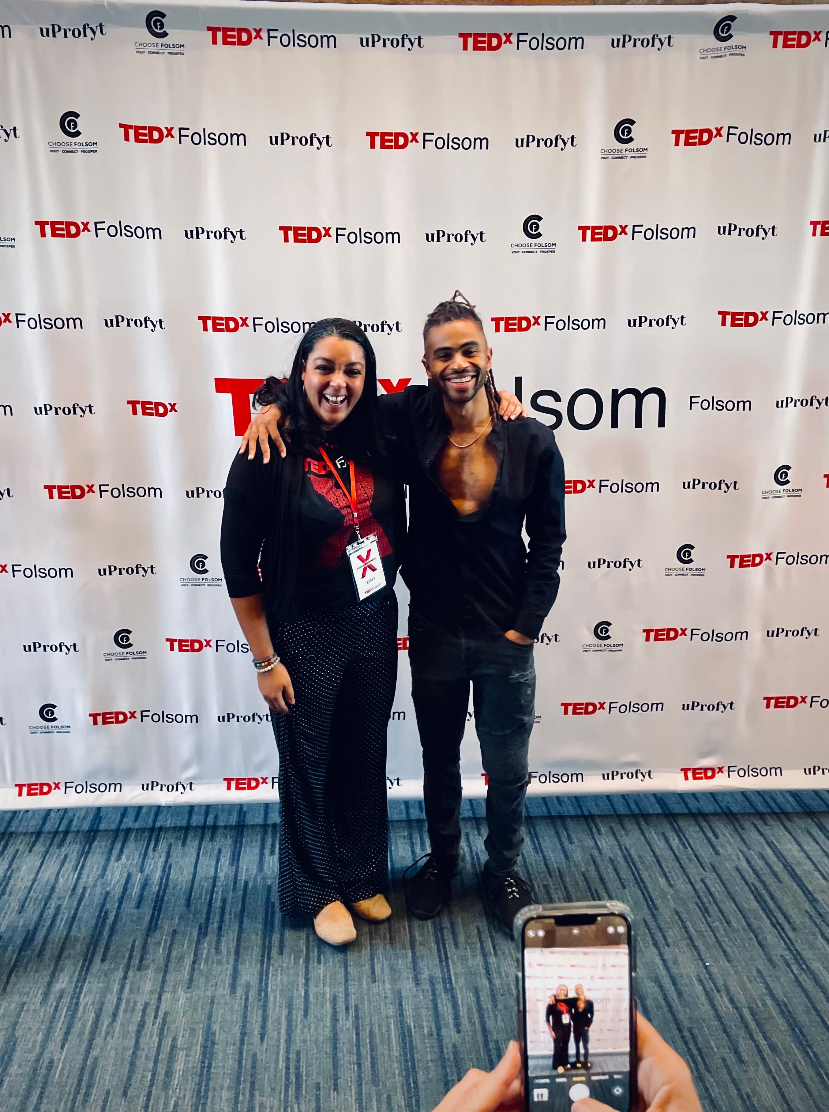 Imari Tuakli speaking on the TEDx stage