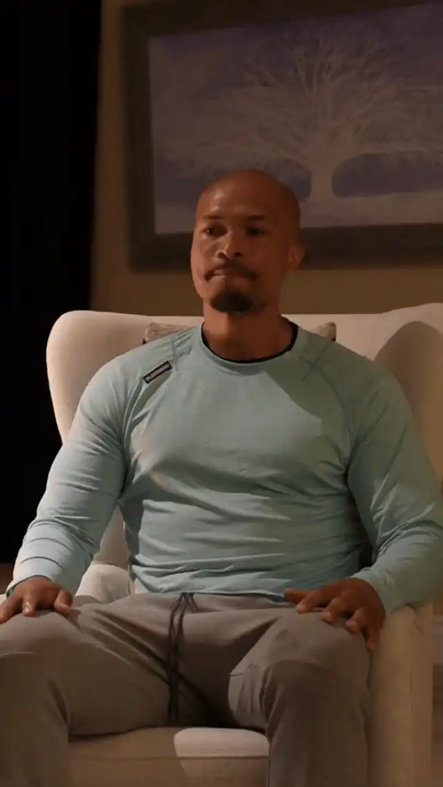 A retreat participant practicing calm presence during a boa constrictor exercise