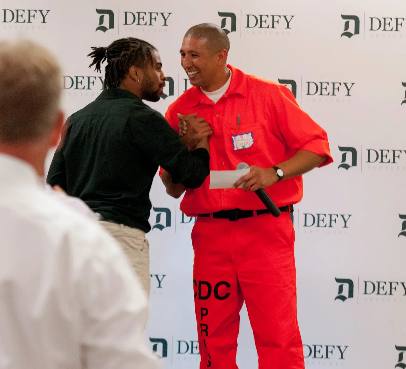 Imari congratulating the winner of the prison pitch competition
